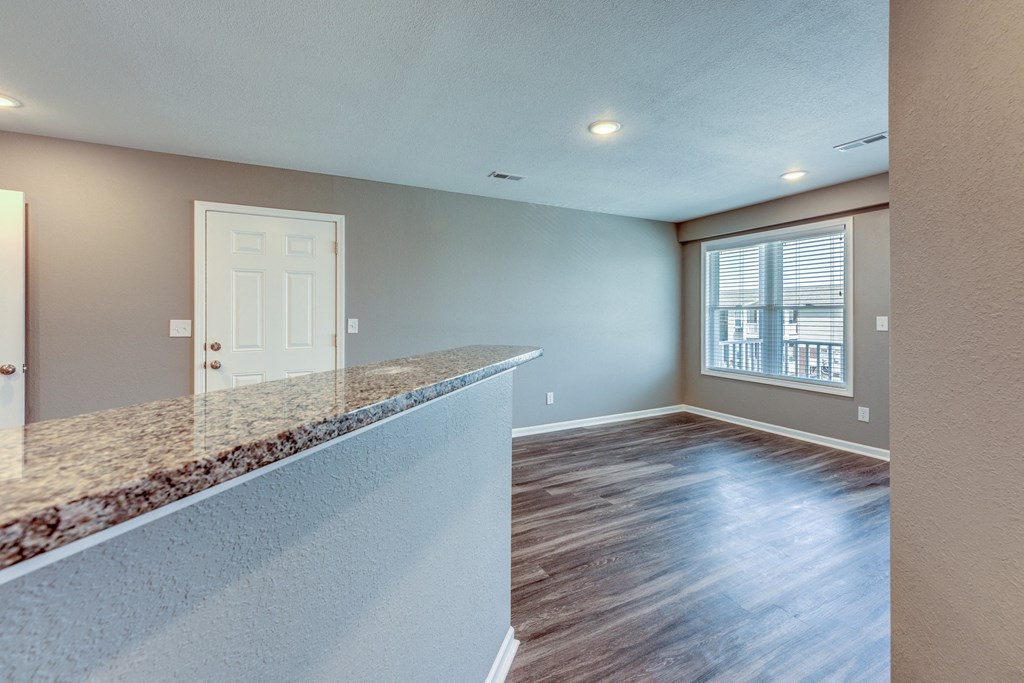 A room with a wooden floor and a white door.