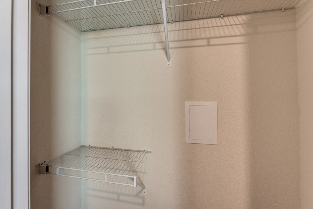 Empty shelves in a white refrigerator.