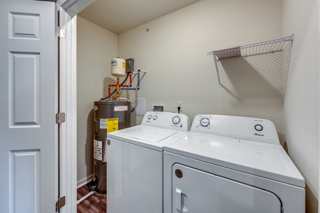 A white washer and dryer in a small laundry room.