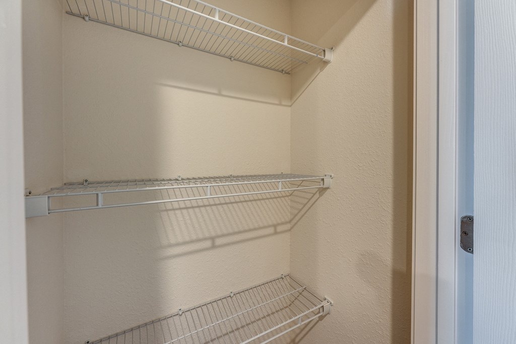 Empty shelves in a white refrigerator.