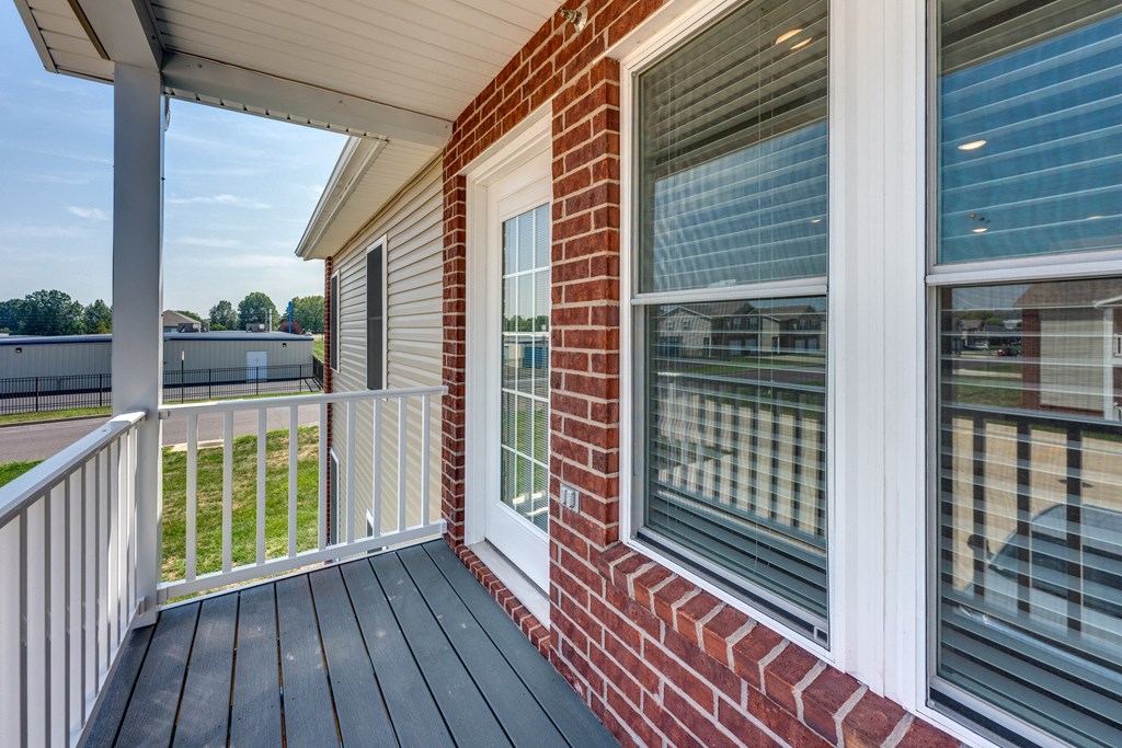 A house with a red brick wall and a white window.
