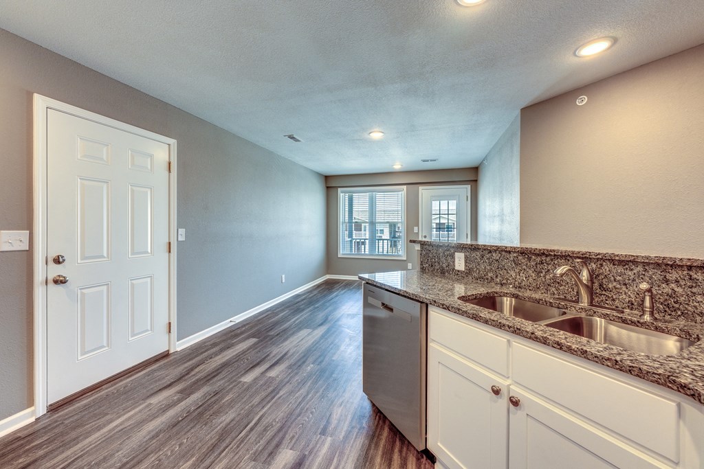 A kitchen with a sink and a window.