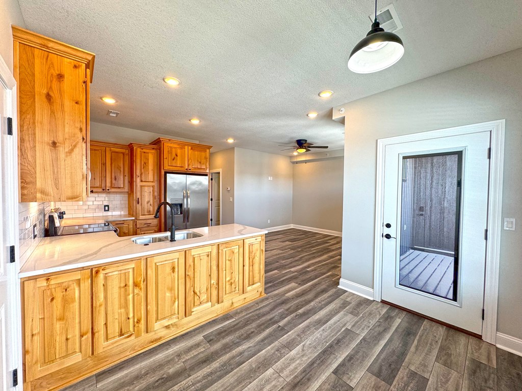 A kitchen with wooden cabinets and a white countertop.