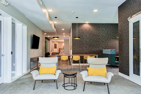 A living room with two chairs and a table.