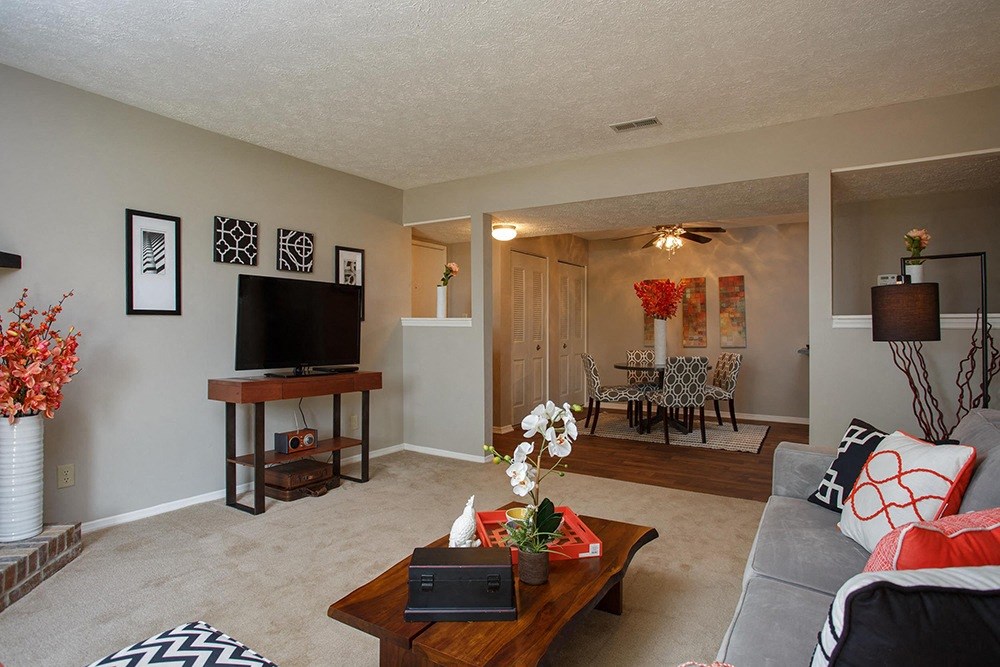 living room with coffee table and table with TV