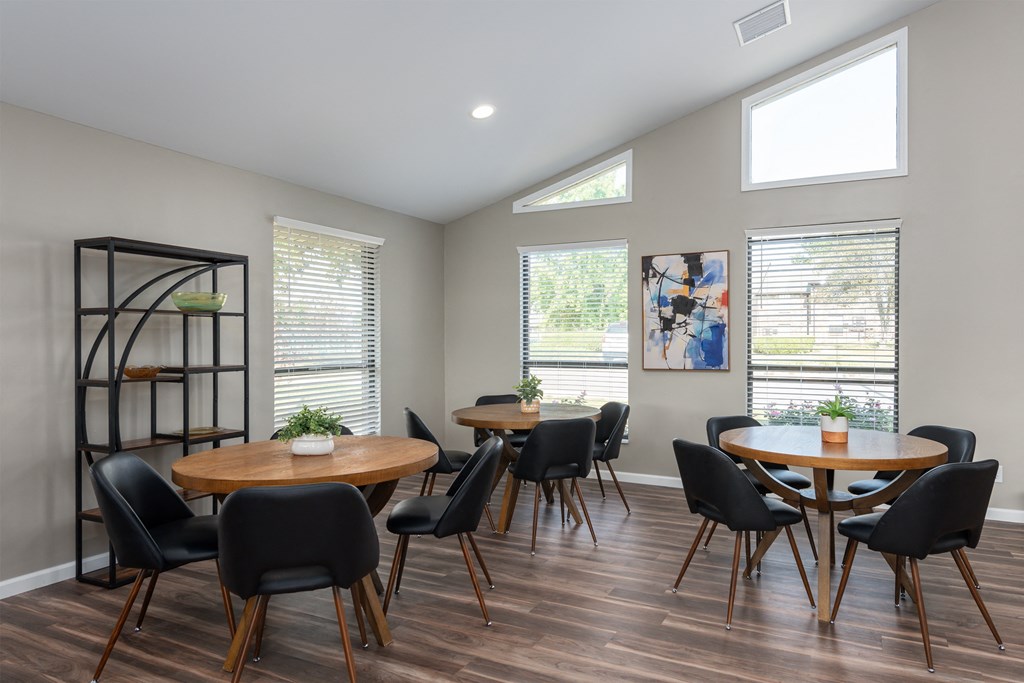 a dining room with tables and chairs and windows