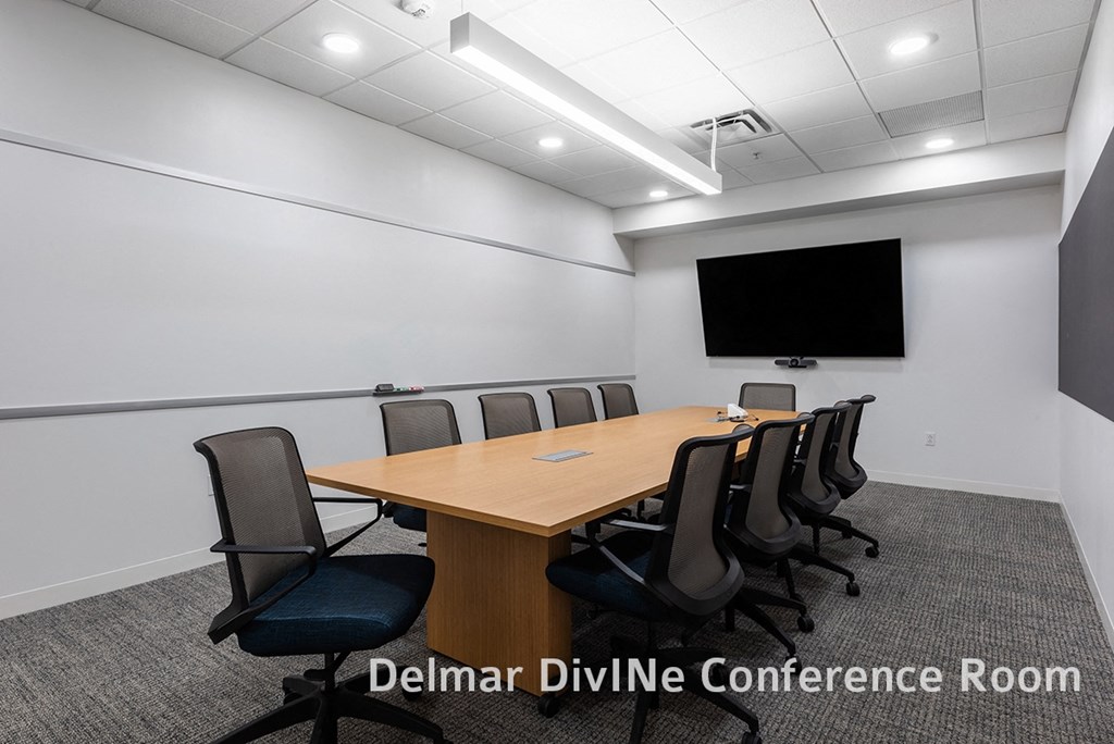conference room with conference table, seating, white board wall and TV at The Residences at Delmar DivINe, St Louis, MO, 63112