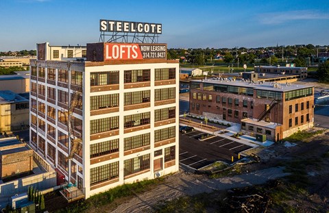 an aerial view of a building with a sign on top of it