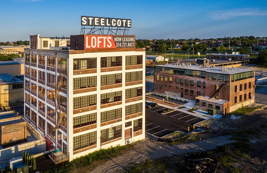 an aerial view of a building with a sign on top of it