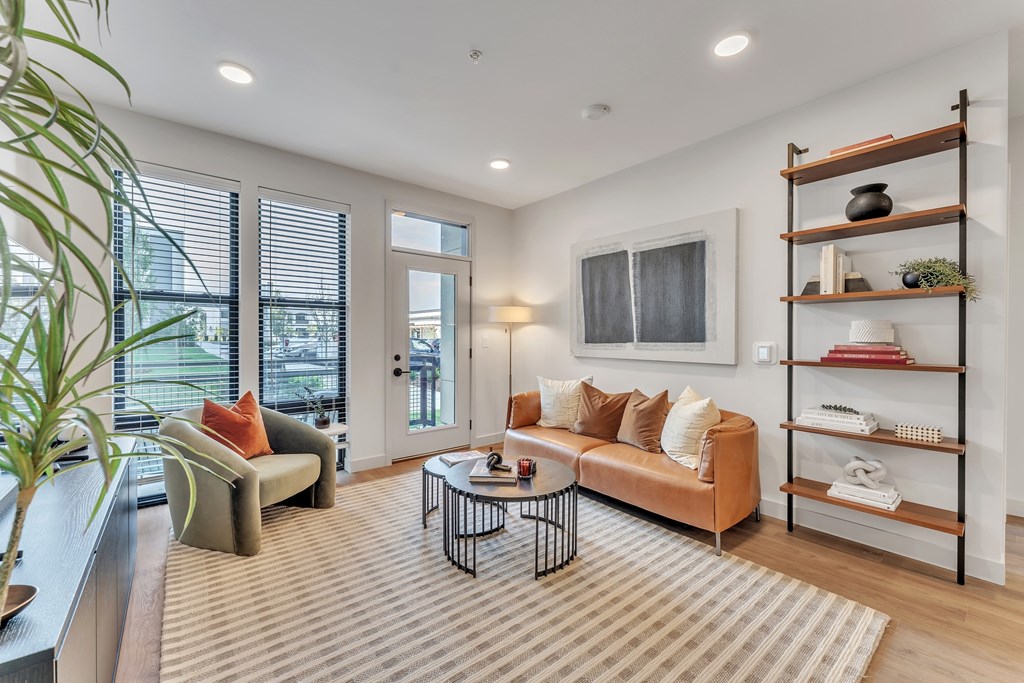 A living room with a sofa, armchair, and a coffee table.