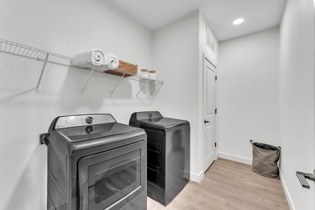 A kitchen with a black oven and a black fridge.
