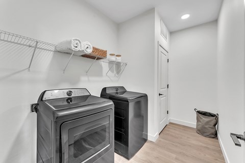 A kitchen with a black oven and a black fridge.
