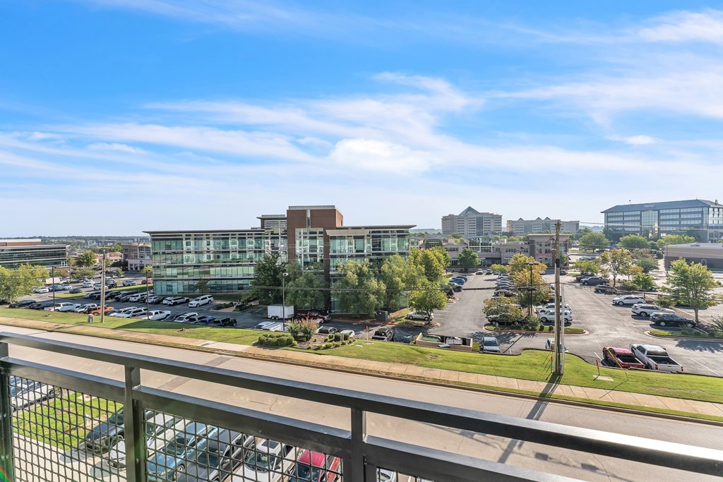 A parking lot with cars and a building in the background.