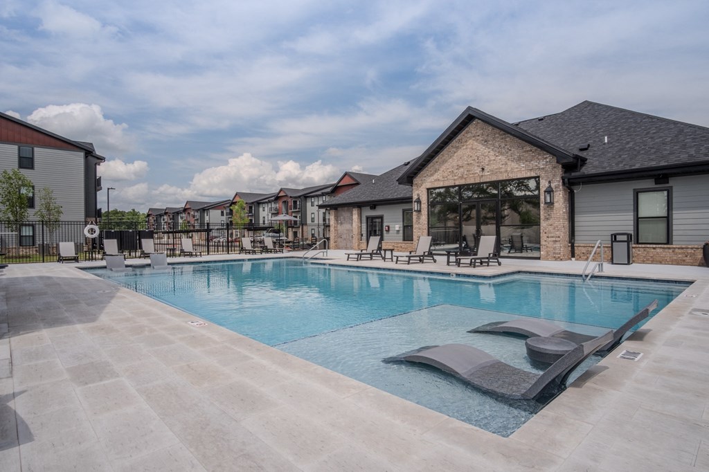 Pool with a clubhouse behind Pool with a clubhouse behind at The Junction at Rogers, Rogers, 72756