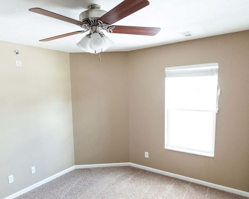 Bedroom with one window and ceiling fan