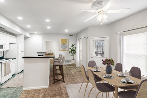 A modern kitchen with a dining table set for four.