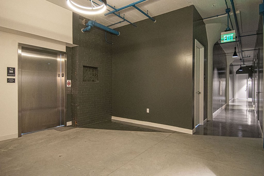 a large empty room with a lobby and a door