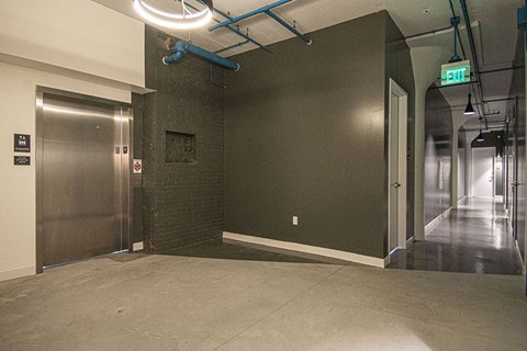 a large empty room with a lobby and a door