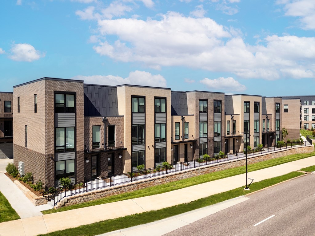 a row of townhouses on the side of a street