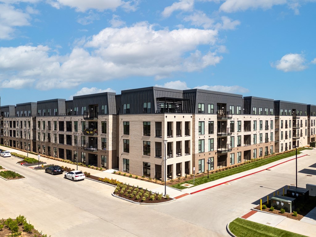 an aerial view of a row of apartment buildings on a city street