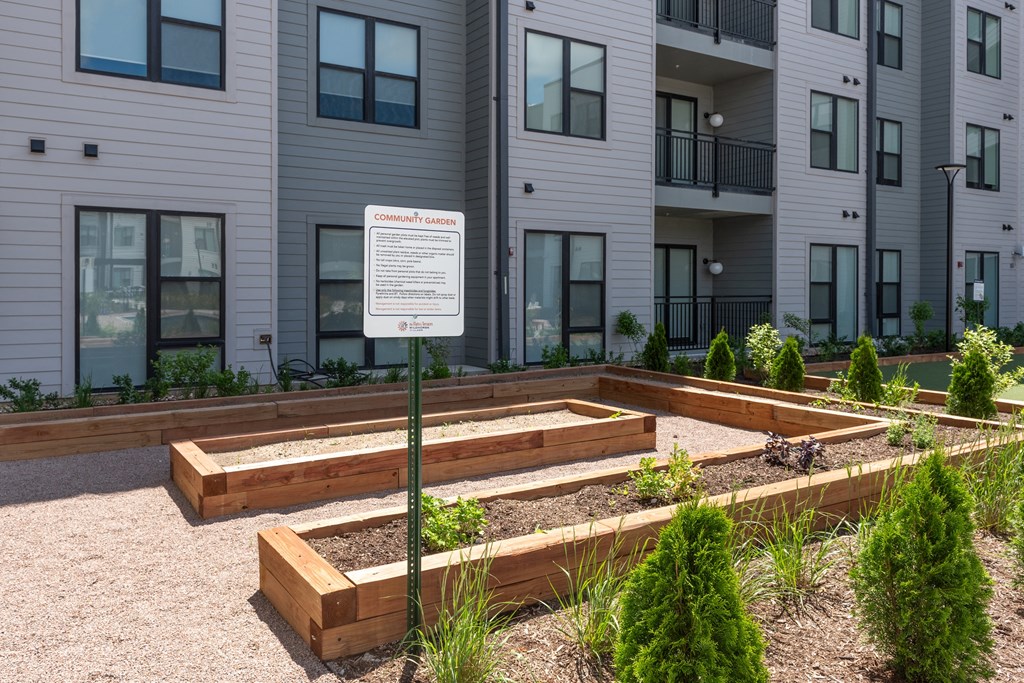 a community garden in front of an apartment building