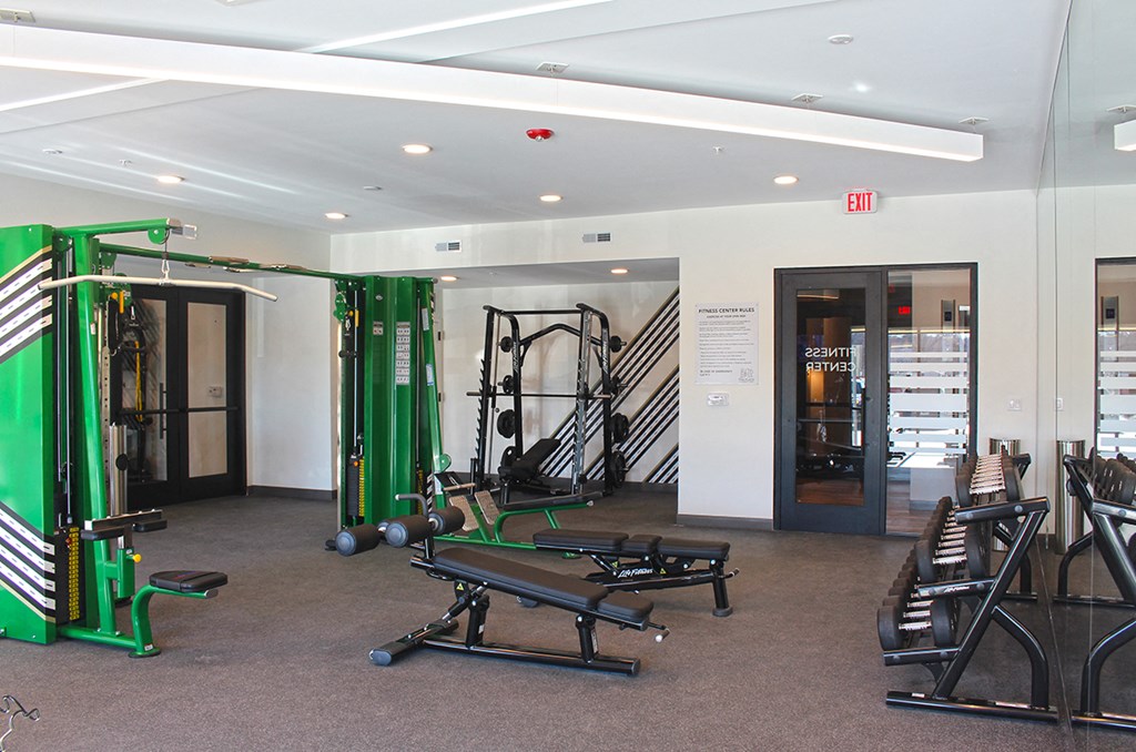 a fitness room with weights and other exercise equipment in a building