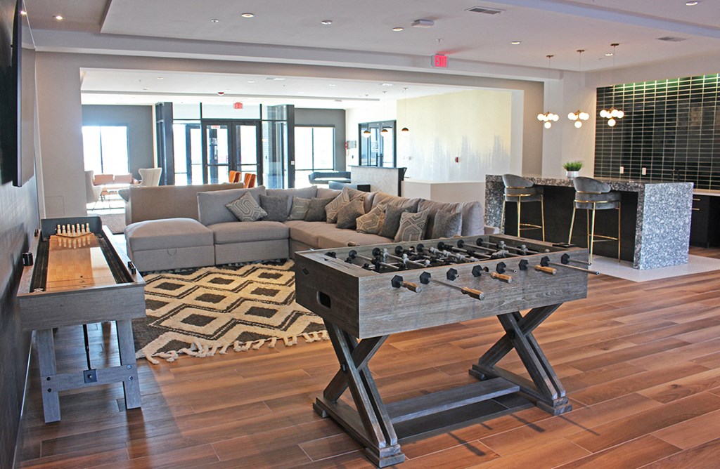 a living room with a foosball table and a couch