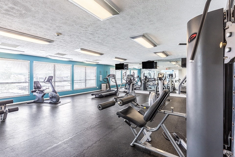 room with dark flooring and weigh lifting equipment