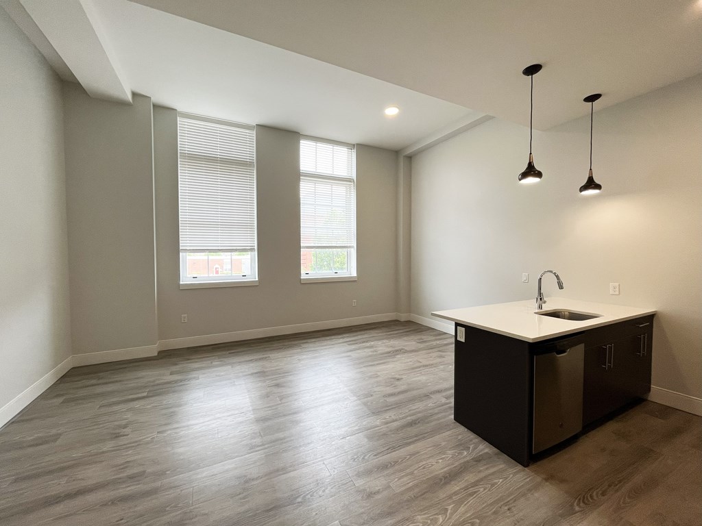 A kitchen area with a sink and a window.