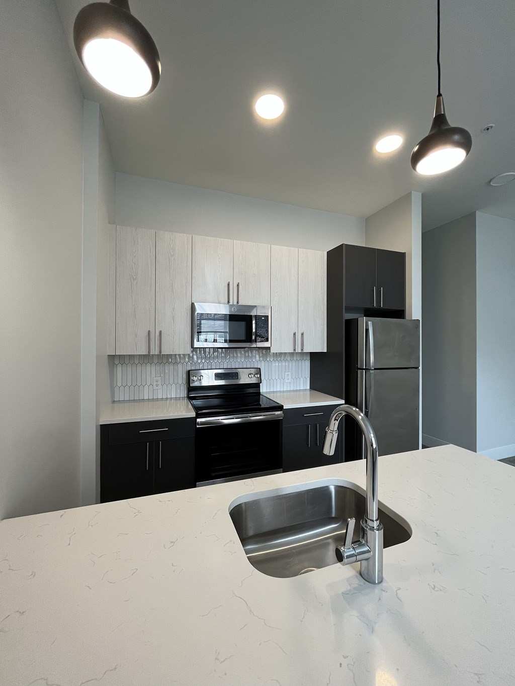 A modern kitchen with a sink and cabinets.
