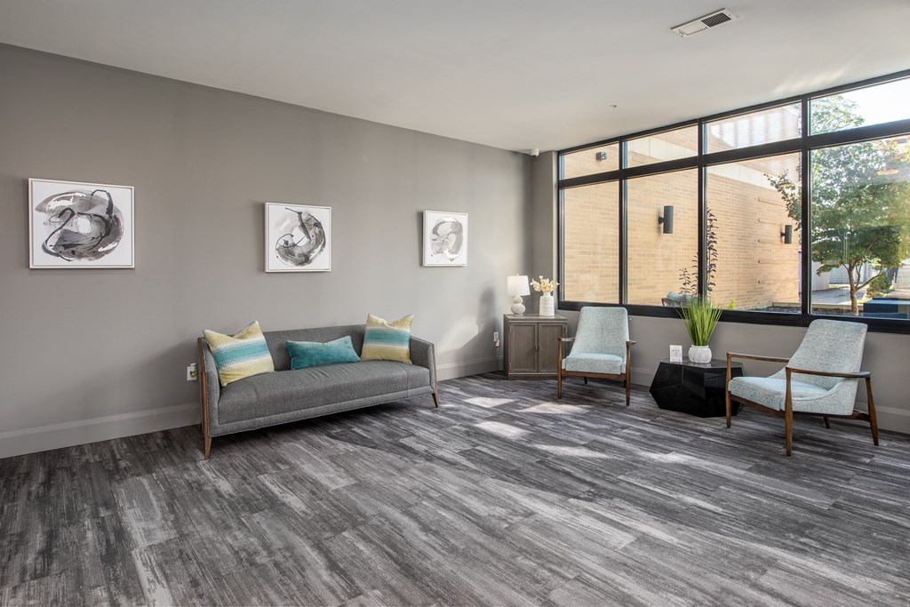a living room with a couch and two chairs and a window at Hibernia Apartments, Missouri, 63139