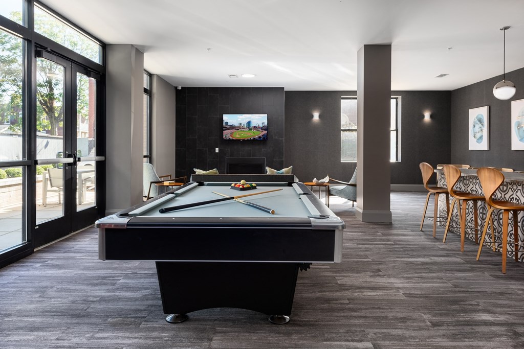 Hibernia resident lounge with pool table, large TV, and built-in fireplace at Hibernia Apartments, St Louis