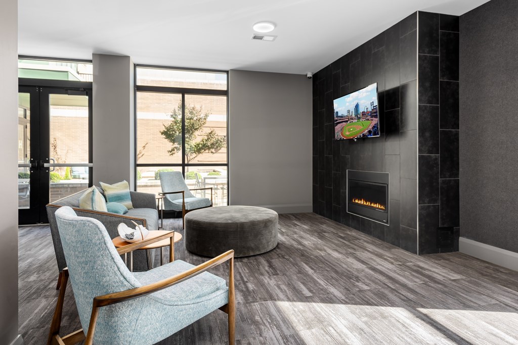 Hibernia resident lounge with large TV, built-in fireplace and conversational seating at Hibernia Apartments, St Louis, Missouri