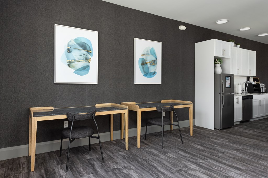 a dining room with a table and chairs and two paintings on the wall at Hibernia Apartments, St Louis, MO