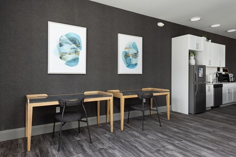 a dining room with a table and chairs and two paintings on the wall at Hibernia Apartments, St Louis, MO