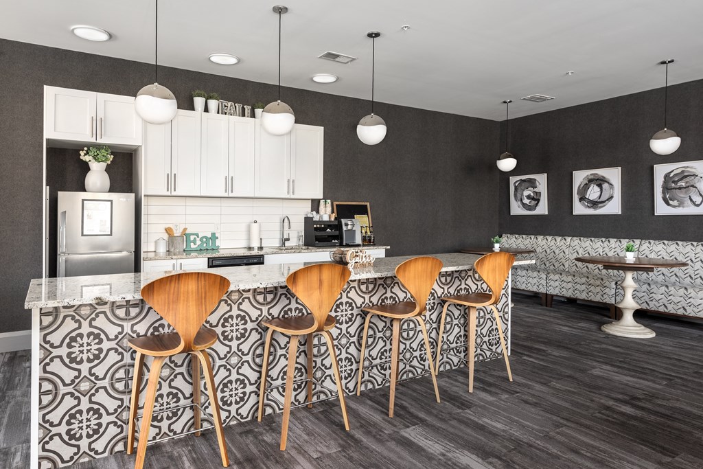 a kitchen with bar stools and a counter top in a living room at Hibernia Apartments, St Louis, 63139