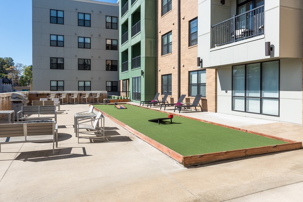 Hibernia resident amenity deck with gaming turf, conversational seating and grilling station at Hibernia Apartments, Missouri, 63139