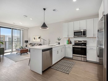 a kitchen with white cabinets and stainless steel appliances - Photo Gallery 31