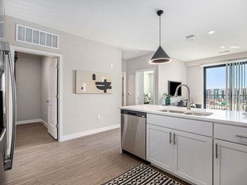 a kitchen with white cabinets and a stainless steel dishwasher - Photo Gallery 30