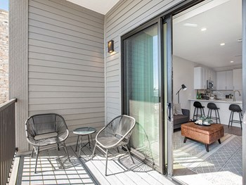 a small balcony with two chairs and a coffee table - Photo Gallery 23
