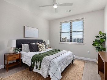 a bedroom with a large bed and a ceiling fan - Photo Gallery 22