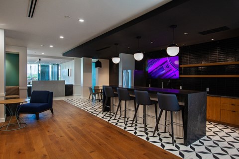 a bar area in the lobby of a building with black and white tiles and a purple screen  at 2200 LaSalle, St Louis, MO, 63104
