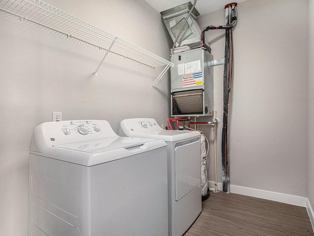 our apartments have a laundry room with a washer and dryer  at Signature at West Pryor, Missouri