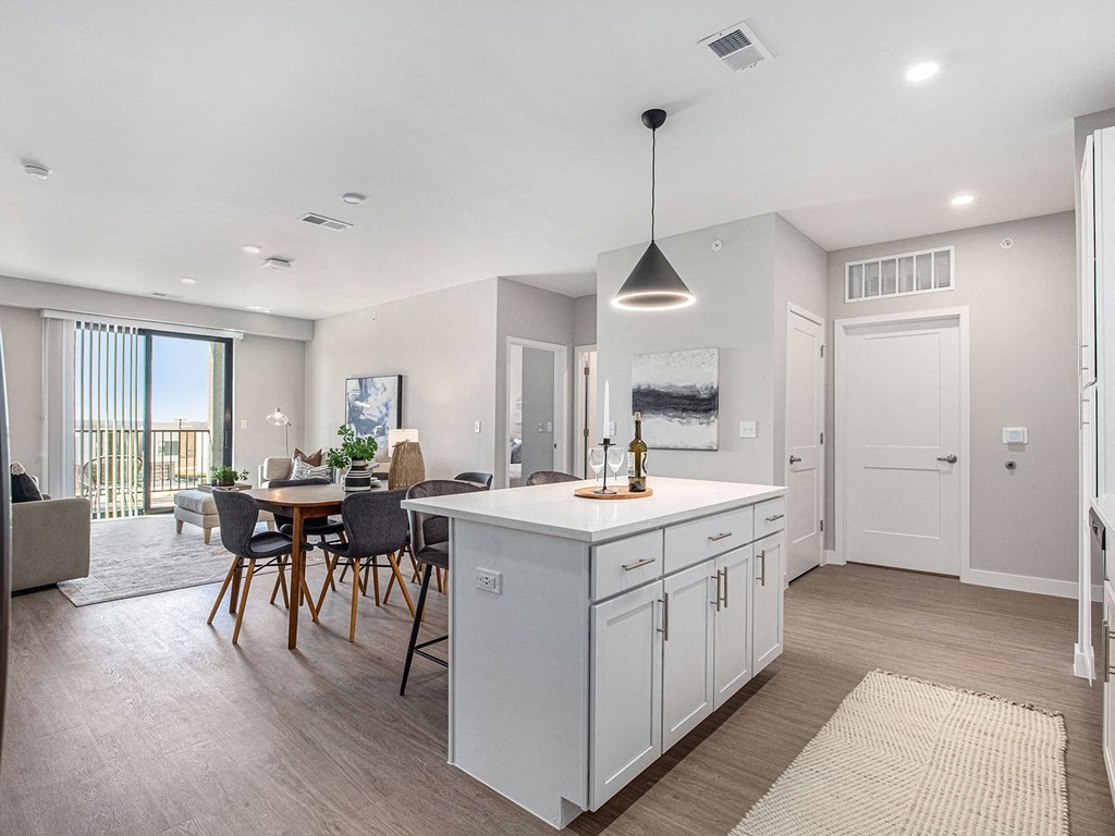a kitchen and dining room with a view of the ocean  at Signature at West Pryor, Missouri