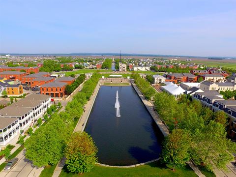 an aerial view of a river with a fountain in the middle