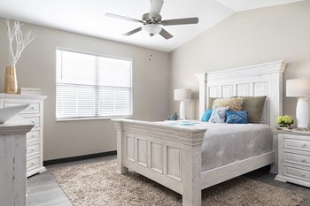 bedrom with overhead ceiling fan and white bed - Photo Gallery 6