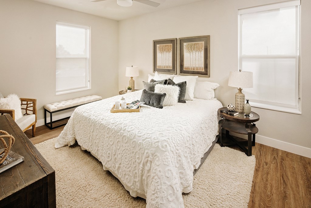 a bedroom with a large bed and two windows a bedroom with a large bed and two windows at 44 West Luxury Living, Valley Park, MO, 63088
