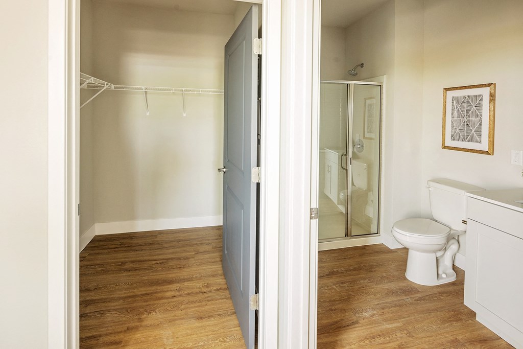 a bathroom with a toilet and a shower and a sliding glass door at 44 West Luxury Living, Valley Park, MO, 63088