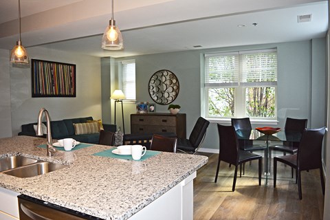 A kitchen with a table and chairs.