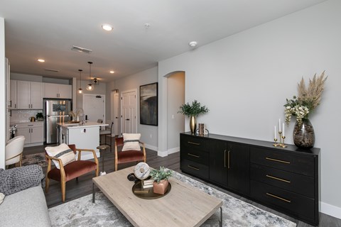 A modern living room with a wooden coffee table and a black cabinet.